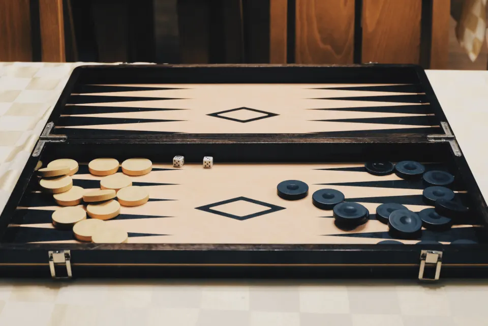 Friends gathered around a board game table